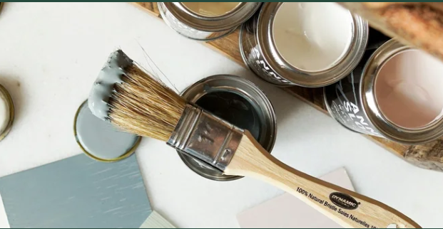 Paint brush and open cans of paint samples